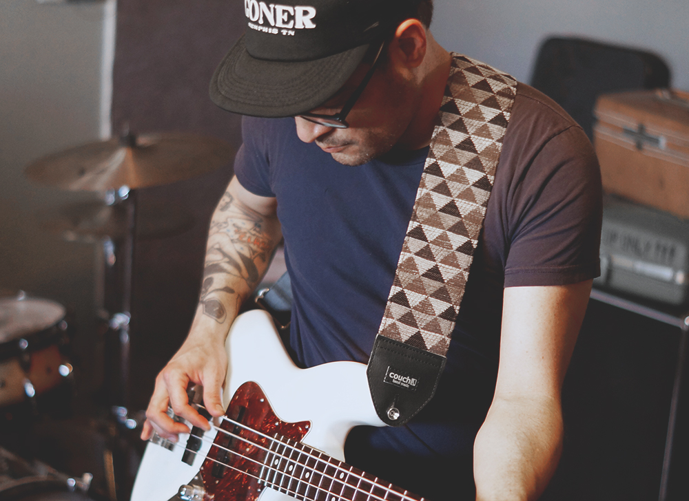 The triangle pattern 3 inch strap worn on a bass