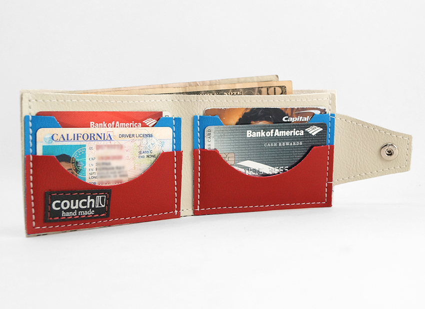 The wallet open, showing red and blue card pockets, a cash compartment and the Couch label