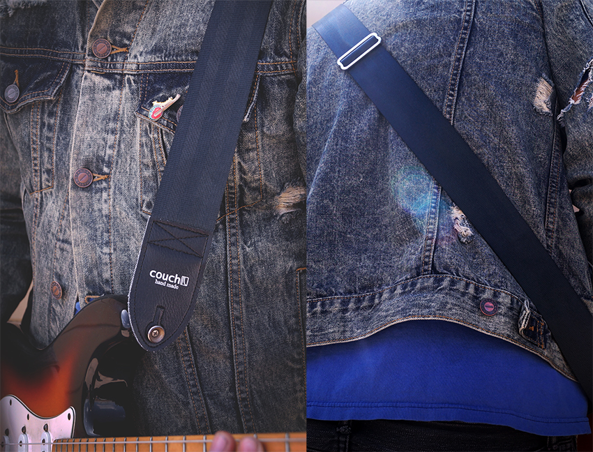 The Plain Black seatbelt guitar strap worn over a denim jacket