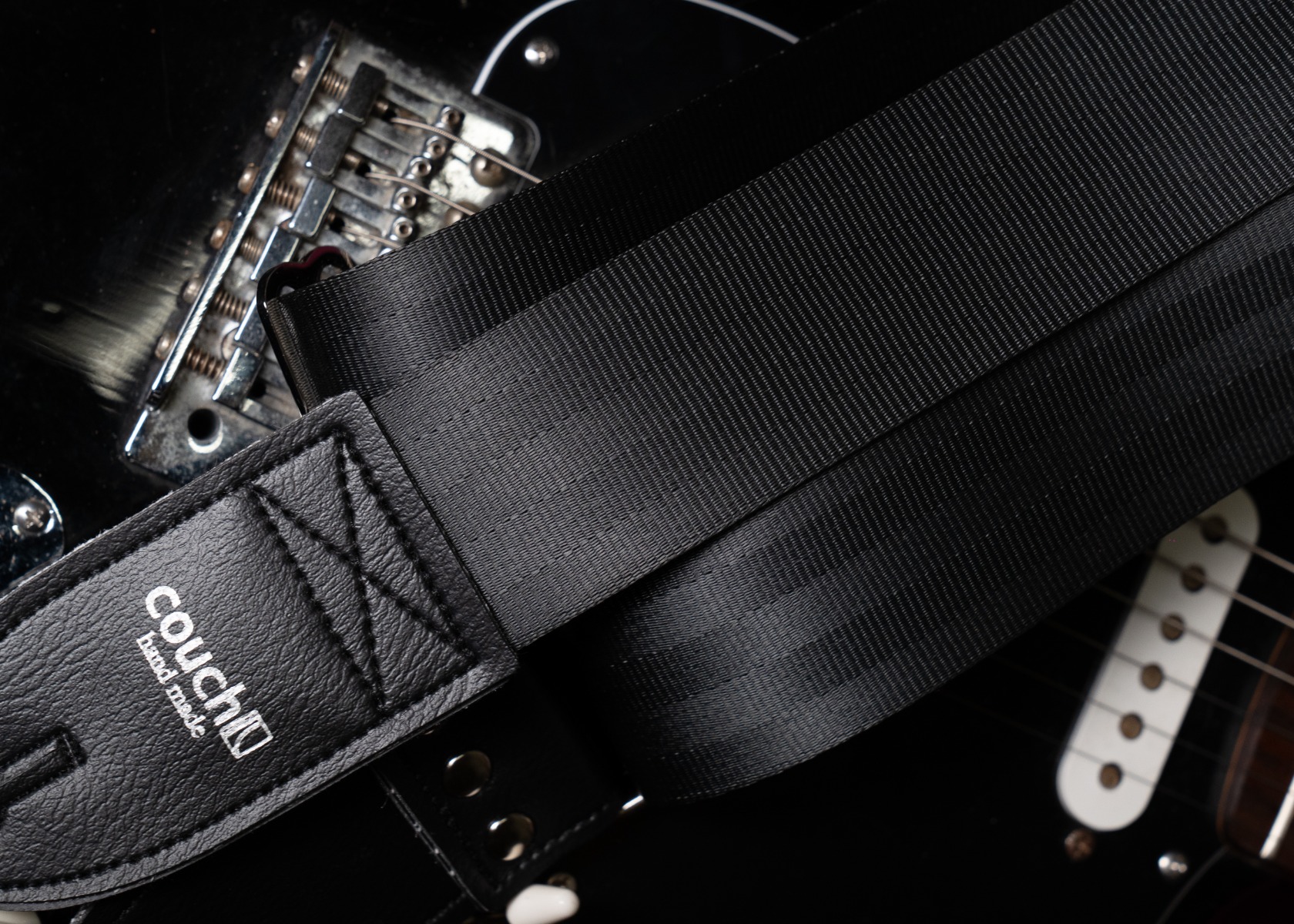 Close-up of the recycled automotive seatbelt webbing on the Plain Black guitar strap