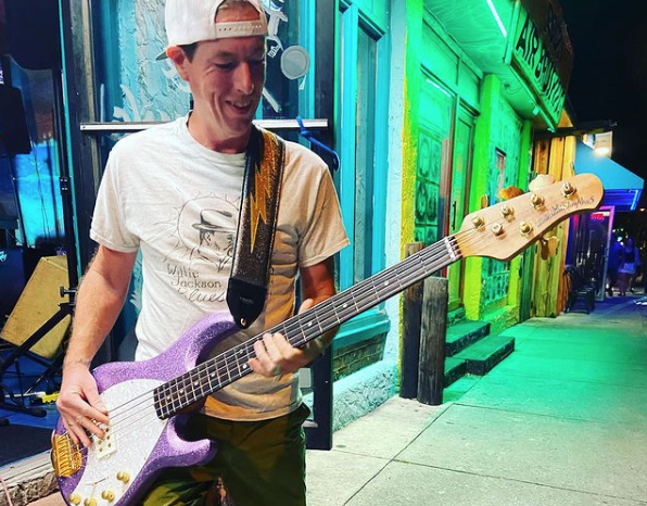 A bass player wearing the 3 inch Mega Bolt strap on stage