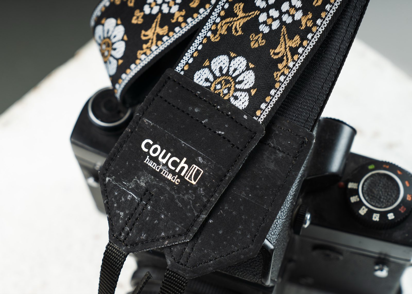 Black cork vegan end tab stamped with the gold Couch logo