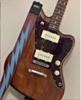 Fender Jazzmaster in stained wood, with custom bolt guitar strap