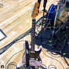 stratocaster style guitar in pink with black and white bolt strap