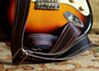 The Dark Walnut Vintage Cadillac Sunburst Deadstock Luggage Guitar Strap