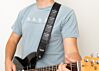 Guitar player with guitar strap designed by Fred Armisen