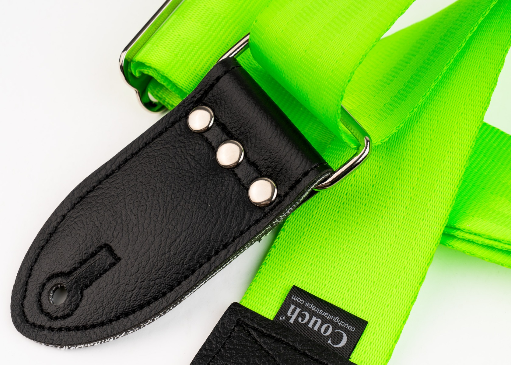 Close-up of the stainless steel rivets, x-box stitch and keyhole on the neon green strap's end tab