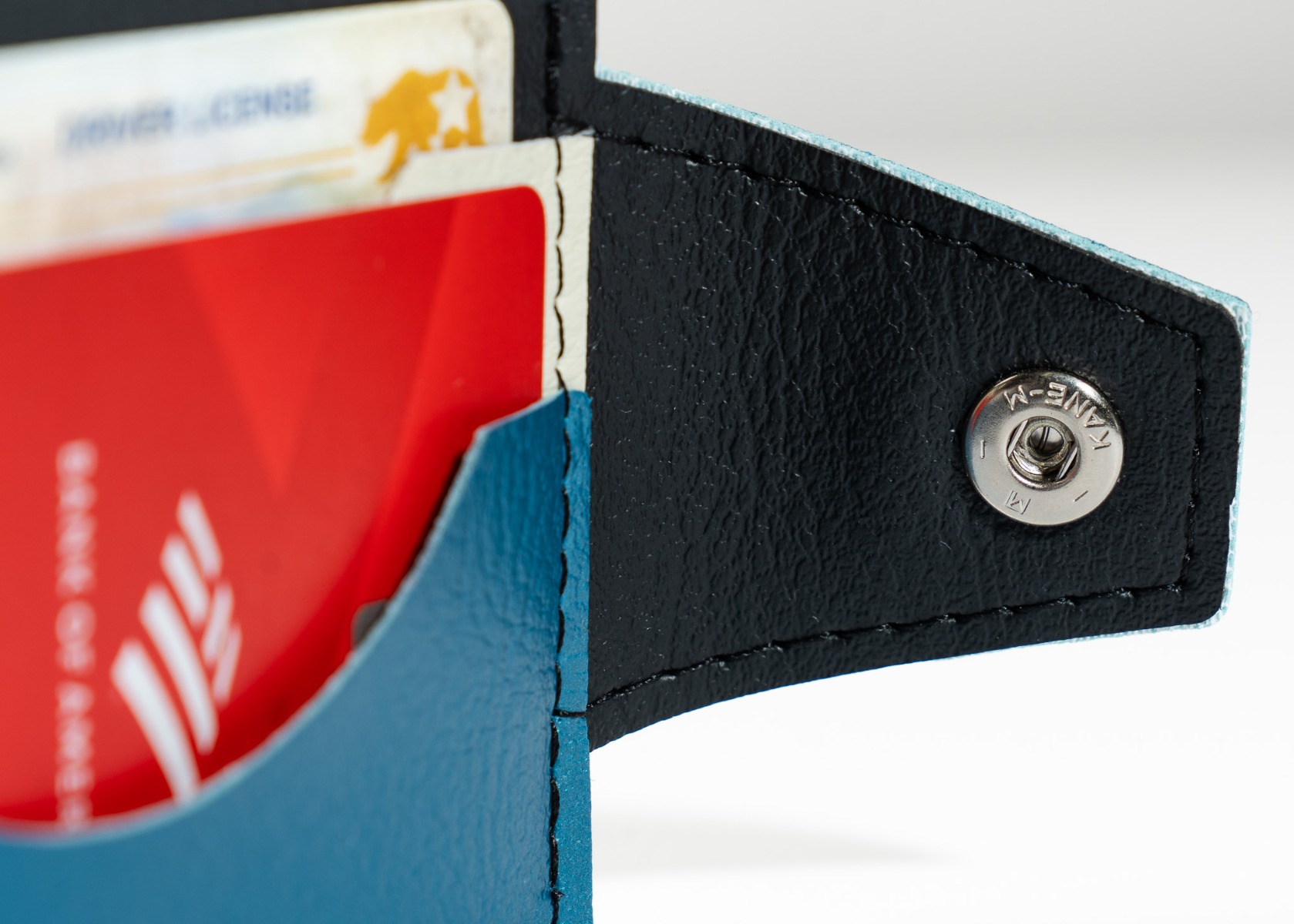 The steel snap closure and scooped card pocket on the Jet Age wallet