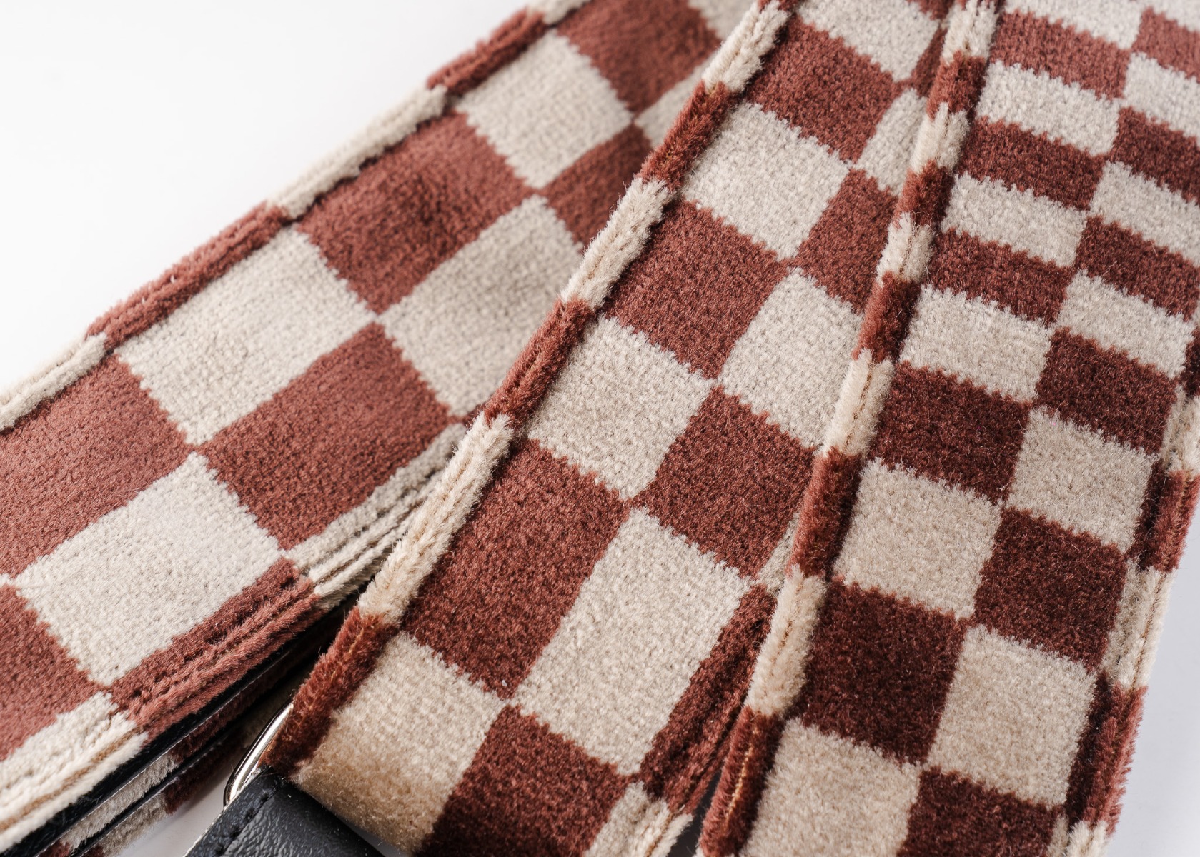 Close-up of the vintage Pasha check upholstery fabric on The Pasha guitar strap