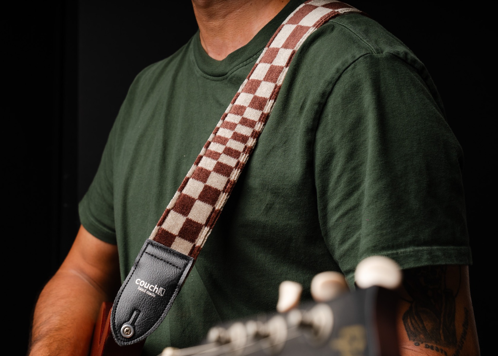 The Pasha guitar strap worn over the shoulder