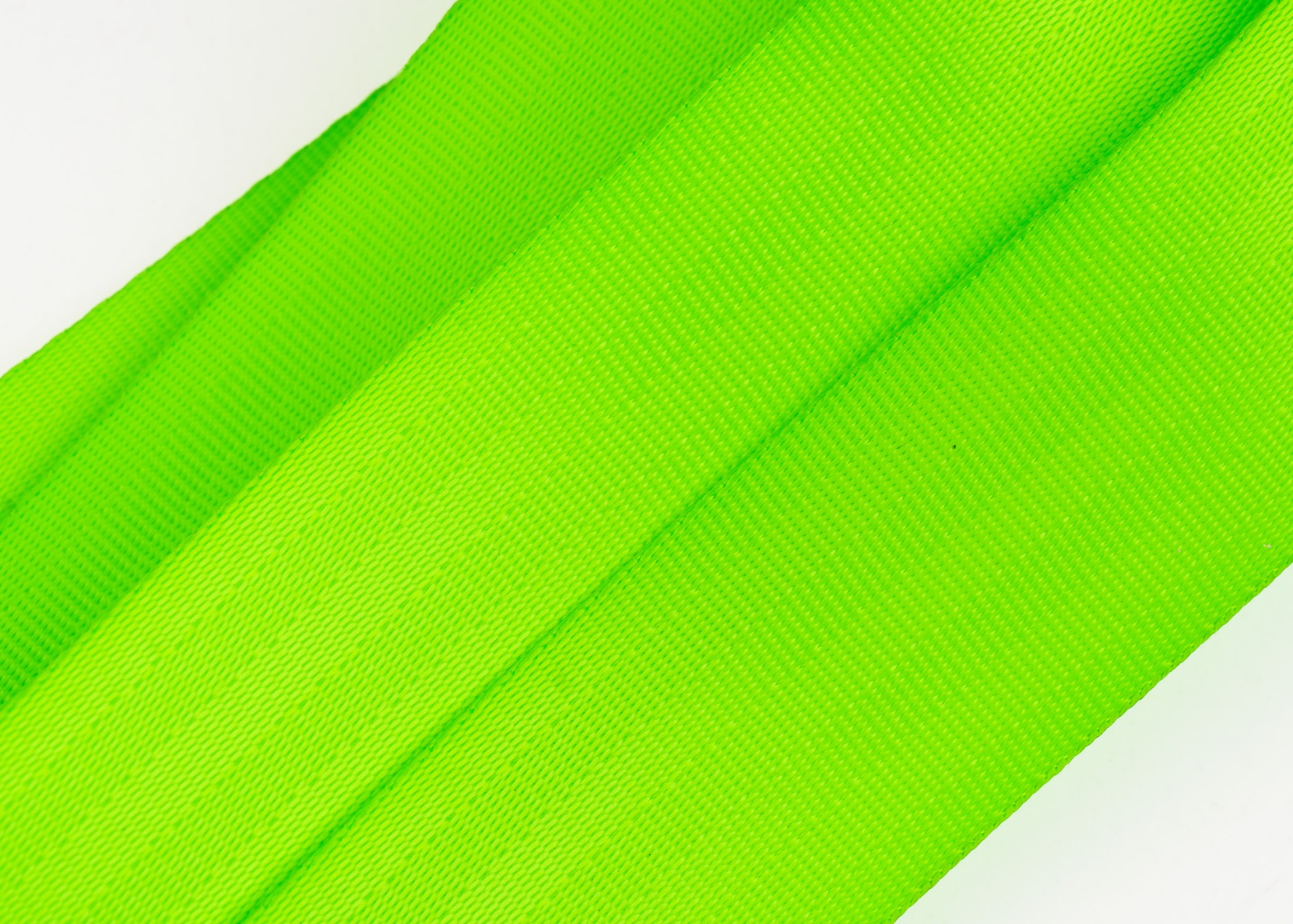Close-up of the neon green seatbelt webbing texture