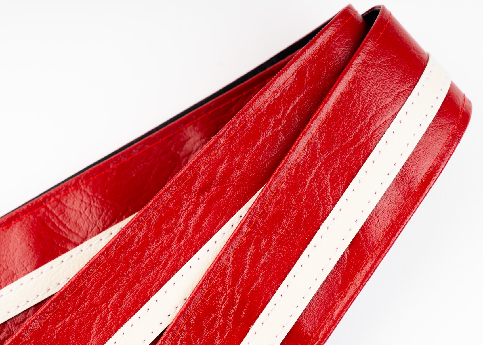 Close-up of the cream racing stripe and contrast stitching on the Red Racer-X strap