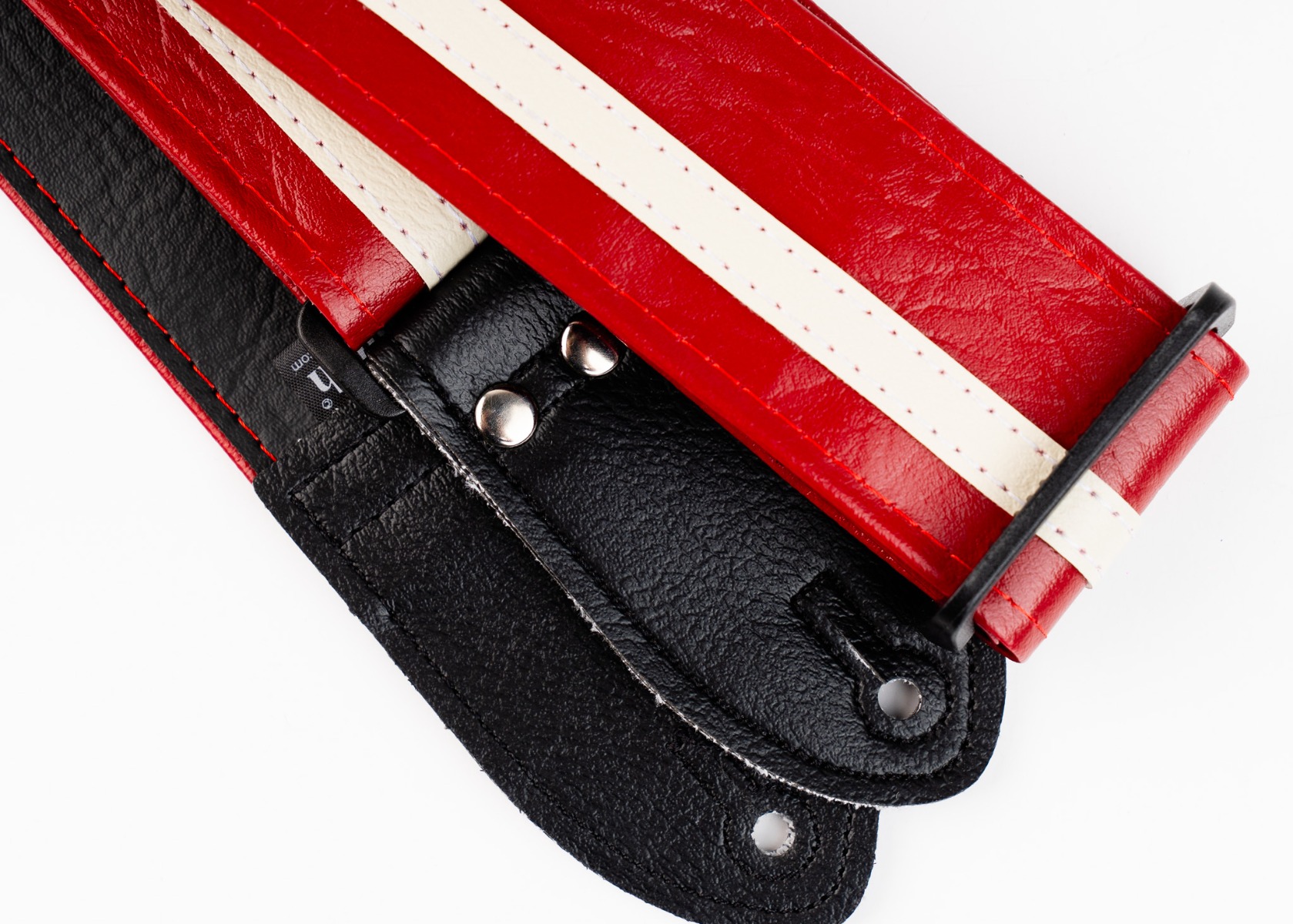 The black backing, woven label and slide adjuster on the Red Racer-X strap
