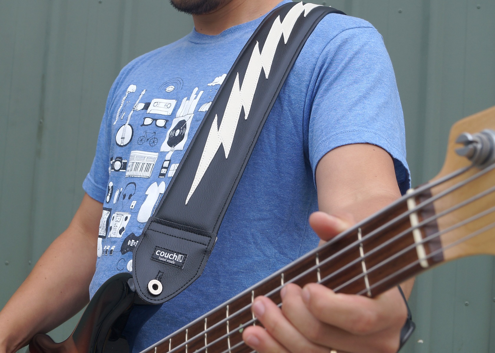 The 3 inch wide Mega Bolt guitar strap worn over the shoulder