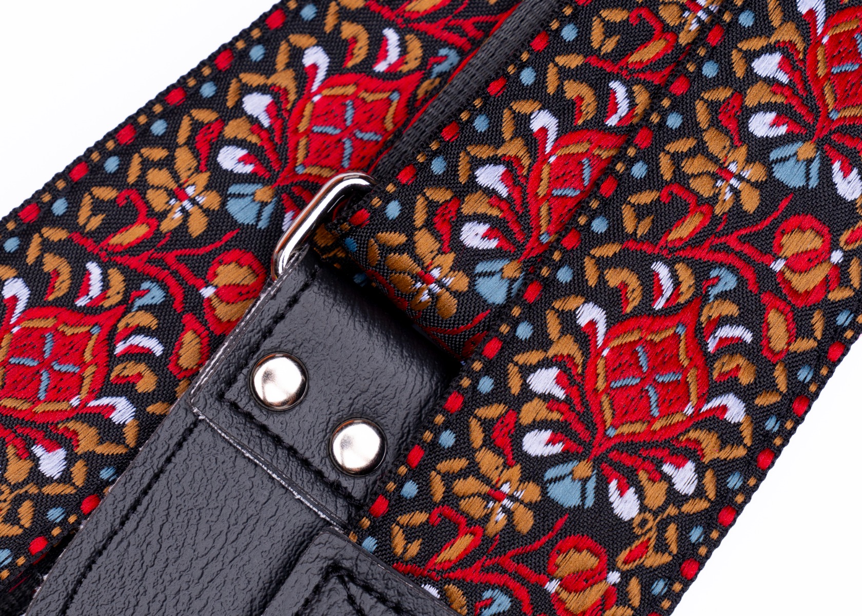 Close-up of the hand-tooled stainless steel rivets and adjuster buckle