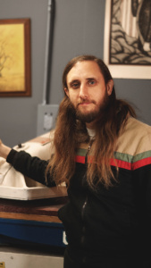 AARON ARCHAMBAULT <br>SHIPPING LEAD, PRODUCTION ASSISTANT <br>Aaron is somewhat of a legendary musician around town and it’s common to see him sitting in on bass or guitar in another great new band. Being of Hawiian descent, Aaron has taken a recent interest in lap steel and is fully into studying and performing his take on traditional playing. He is the man who ships your order and you’ll often see his name, and sometimes his drawings, scribbled on your order.  